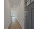Hallway with wood-look floors, leading to a bright, airy living space at 695 Sunstone Ln, Lawrenceville, GA 30043