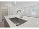 The kitchen features a large island with a stainless steel sink and modern faucet at 695 Sunstone Ln, Lawrenceville, GA 30043