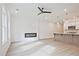 Open living space featuring wood-look floors, modern fireplace, and view of the kitchen at 695 Sunstone Ln, Lawrenceville, GA 30043