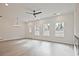Open-concept living room with ample natural light and a modern ceiling fan at 695 Sunstone Ln, Lawrenceville, GA 30043