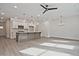 Open concept kitchen and living area with a center island and modern lighting at 695 Sunstone Ln, Lawrenceville, GA 30043
