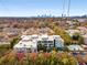 Stunning aerial view of the condo building with a pool and a city skyline backdrop at 130 Arizona Ne Ave # 104, Atlanta, GA 30307