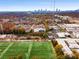 Aerial view of modern townhouses, soccer field, and city skyline at 130 Arizona Ne Ave # 104, Atlanta, GA 30307