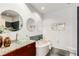 Bright bathroom featuring a modern vanity, round mirrors, a bathtub, and concrete floors at 130 Arizona Ne Ave # 104, Atlanta, GA 30307