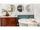 Bathroom featuring a modern vanity, round mirrors, a bathtub, and concrete floors at 130 Arizona Ne Ave # 104, Atlanta, GA 30307