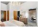 Bright bedroom features concrete ceiling, chandelier, and glass door to patio at 130 Arizona Ne Ave # 104, Atlanta, GA 30307