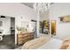 Bright bedroom with a chandelier, modern furniture, and access to a balcony at 130 Arizona Ne Ave # 104, Atlanta, GA 30307