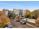 View of the building exterior with adjacent parking and a glimpse of the community pool at 130 Arizona Ne Ave # 104, Atlanta, GA 30307