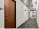 Contemporary hallway featuring gray carpet, modern lighting, and doors to various units at 130 Arizona Ne Ave # 104, Atlanta, GA 30307