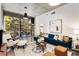 Bright living room with concrete ceiling, floor-to-ceiling windows, and a comfortable blue sofa at 130 Arizona Ne Ave # 104, Atlanta, GA 30307