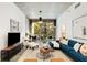 Bright living room featuring a blue sectional sofa and a large window with views to the outside balcony at 130 Arizona Ne Ave # 104, Atlanta, GA 30307