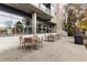 Outdoor patio featuring multiple seating areas, a grill, and views of mature trees at 130 Arizona Ne Ave # 104, Atlanta, GA 30307