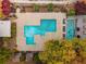 Overhead shot of the rectangular shaped swimming pool, separate smaller pool, wooden gazebos, and tree coverage at 130 Arizona Ne Ave # 104, Atlanta, GA 30307