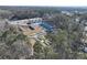 An aerial view of new townhomes nestled in a wooded area with easy access to nearby roads and modern infrastructure at 693 Sunstone Ln, Lawrenceville, GA 30043