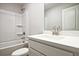 Bright bathroom featuring a shower-tub combo and a white vanity with a modern faucet at 693 Sunstone Ln, Lawrenceville, GA 30043