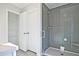 Bathroom featuring a glass-enclosed shower and linen storage at 693 Sunstone Ln, Lawrenceville, GA 30043