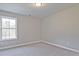 A simple bedroom with neutral carpet and a bright window at 693 Sunstone Ln, Lawrenceville, GA 30043