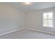 A simple bedroom with neutral carpet and a bright window at 693 Sunstone Ln, Lawrenceville, GA 30043