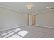 An airy carpeted bedroom with a view of a storage closet at 693 Sunstone Ln, Lawrenceville, GA 30043