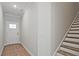 Bright home foyer featuring a staircase, wood-look flooring, and a door to the outside at 693 Sunstone Ln, Lawrenceville, GA 30043