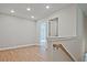 Hallway and staircase with wood floors, white walls, and neutral colors at 693 Sunstone Ln, Lawrenceville, GA 30043