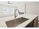 Close up of kitchen island featuring a large stainless sink with faucet at 693 Sunstone Ln, Lawrenceville, GA 30043