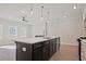 Island features a stainless sink, white countertops, and pendant lighting at 693 Sunstone Ln, Lawrenceville, GA 30043