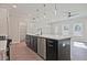 Kitchen island with a stainless steel dishwasher, sink, and plentiful storage at 693 Sunstone Ln, Lawrenceville, GA 30043