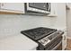 Modern kitchen with stainless steel stove top and white subway tile backsplash at 693 Sunstone Ln, Lawrenceville, GA 30043