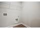 Simple laundry room with hookups and a wire rack shelf at 693 Sunstone Ln, Lawrenceville, GA 30043