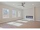 Bright living room with hardwood floors, recessed lighting, and a modern electric fireplace at 693 Sunstone Ln, Lawrenceville, GA 30043