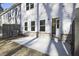 View of a backyard with a concrete patio, grass yard, and an open doorway into the home at 691 Sunstone Ln, Lawrenceville, GA 30043