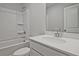 Modern bathroom features a shower-tub combo, white vanity with chrome faucet, and matching commode at 691 Sunstone Ln, Lawrenceville, GA 30043