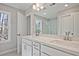Bright bathroom with double sinks, quartz countertops, and a large mirror reflecting a walk-in shower at 691 Sunstone Ln, Lawrenceville, GA 30043