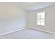 This bedroom features neutral walls, plush carpet, and a window providing natural light at 691 Sunstone Ln, Lawrenceville, GA 30043