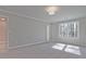 Bright bedroom with soft carpet, a large window letting in natural light, and neutral paint at 691 Sunstone Ln, Lawrenceville, GA 30043