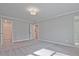 Spacious bedroom with light-colored walls and carpet, and doorways to closets and the bathroom at 691 Sunstone Ln, Lawrenceville, GA 30043