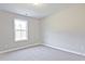This bedroom features neutral walls, plush carpet, and a window providing natural light at 691 Sunstone Ln, Lawrenceville, GA 30043