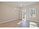 Dining room featuring hardwood floors, chandelier lighting, and an open doorway to the backyard at 691 Sunstone Ln, Lawrenceville, GA 30043