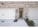 Townhome entrance showing brick facade, garage door, and front door with an open view to the interior at 691 Sunstone Ln, Lawrenceville, GA 30043