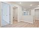 Bright hallway with vinyl floors, white trim and doors leading to various rooms and closets at 691 Sunstone Ln, Lawrenceville, GA 30043