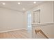 Hallway with wood railing, light-colored walls, and light-colored floors at 691 Sunstone Ln, Lawrenceville, GA 30043