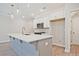 Modern kitchen with a large island, stainless steel appliances, and white cabinets at 691 Sunstone Ln, Lawrenceville, GA 30043