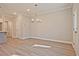 Open-concept living room featuring light-colored floors and modern lighting at 691 Sunstone Ln, Lawrenceville, GA 30043
