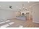 Spacious living room featuring a ceiling fan and an island leading to the kitchen at 691 Sunstone Ln, Lawrenceville, GA 30043