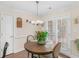 Cozy breakfast nook features a round wooden table and chairs set next to French doors at 775 N Ola N Rd, Mcdonough, GA 30252