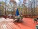 Outdoor deck featuring a dining table set and a grill, surrounded by trees at 775 N Ola N Rd, Mcdonough, GA 30252