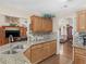 Modern kitchen featuring granite countertops, light wood cabinets, and an open view into the living space at 775 N Ola N Rd, Mcdonough, GA 30252