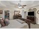 Spacious main bedroom featuring a tray ceiling, ceiling fan, walk-in closet, and ensuite bath at 775 N Ola N Rd, Mcdonough, GA 30252