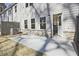 A backyard patio with an open door to kitchen and a gray brick foundation at 689 Sunstone Ln, Lawrenceville, GA 30043